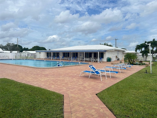 view of swimming pool with a lawn and a patio