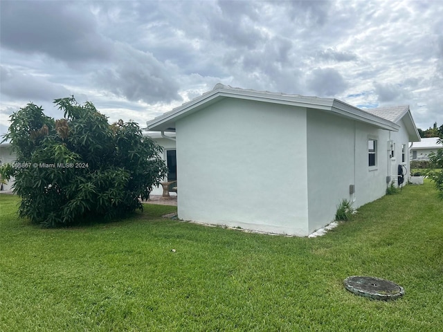 view of home's exterior with a lawn