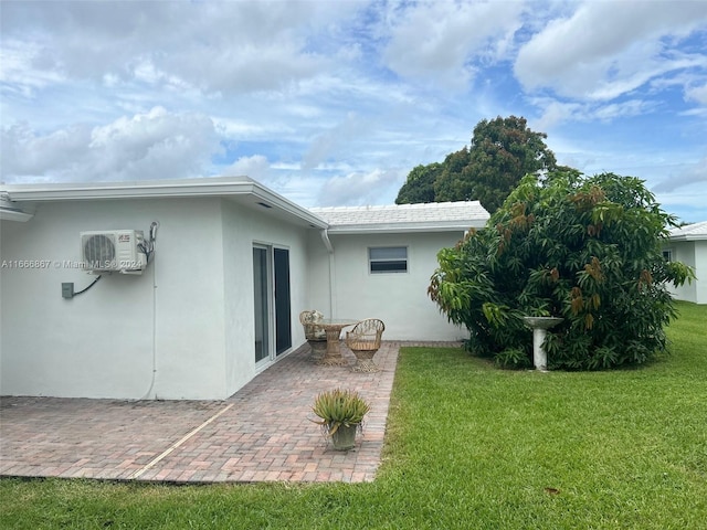 rear view of property featuring ac unit, a patio area, and a yard