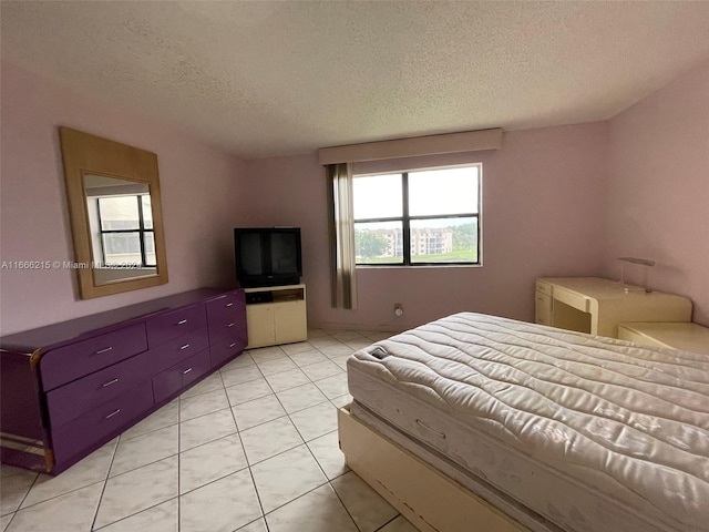 tiled bedroom featuring a textured ceiling