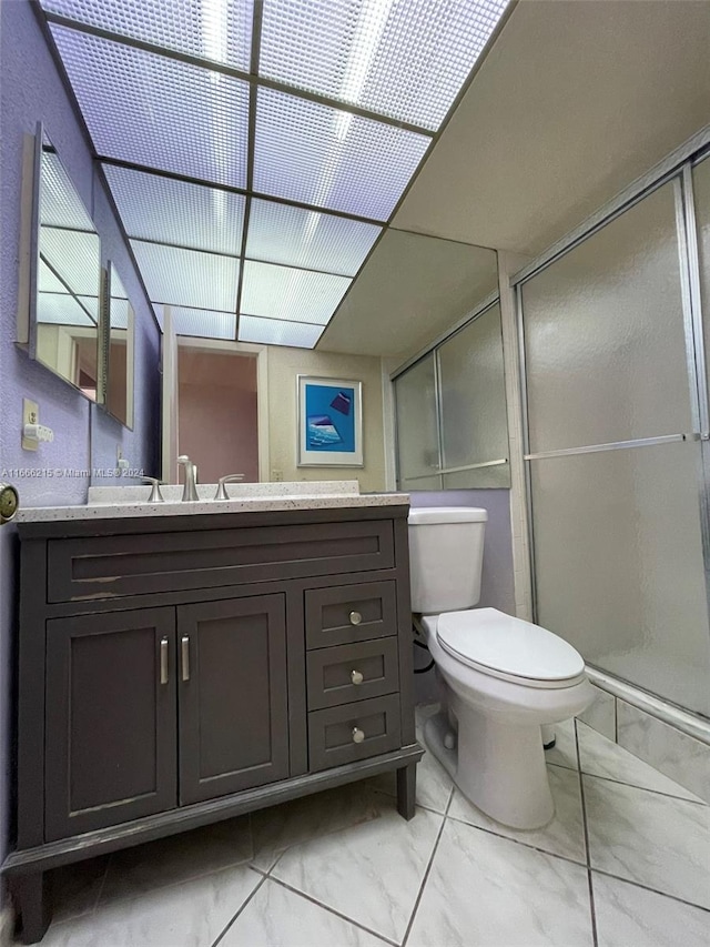 bathroom with walk in shower, vanity, and toilet