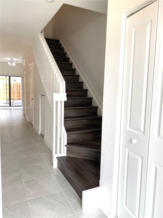 staircase with tile patterned floors