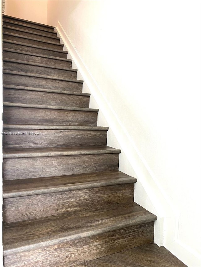 stairs featuring wood-type flooring