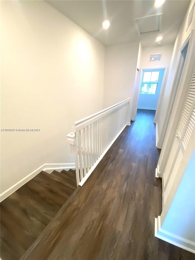 hallway with dark wood-type flooring