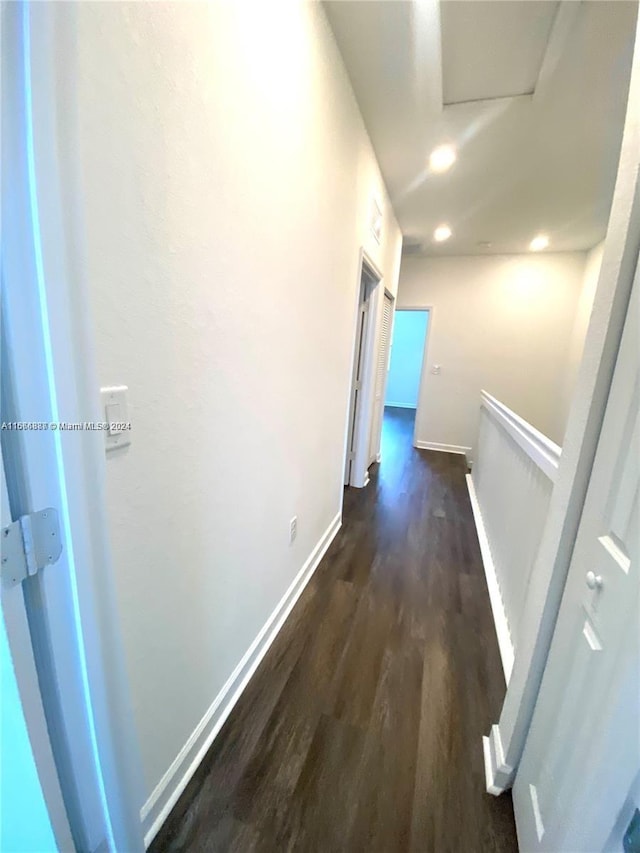 corridor with dark hardwood / wood-style floors