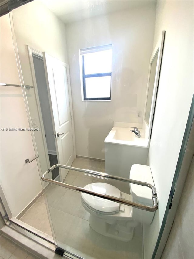 bathroom featuring tile patterned floors, vanity, and toilet