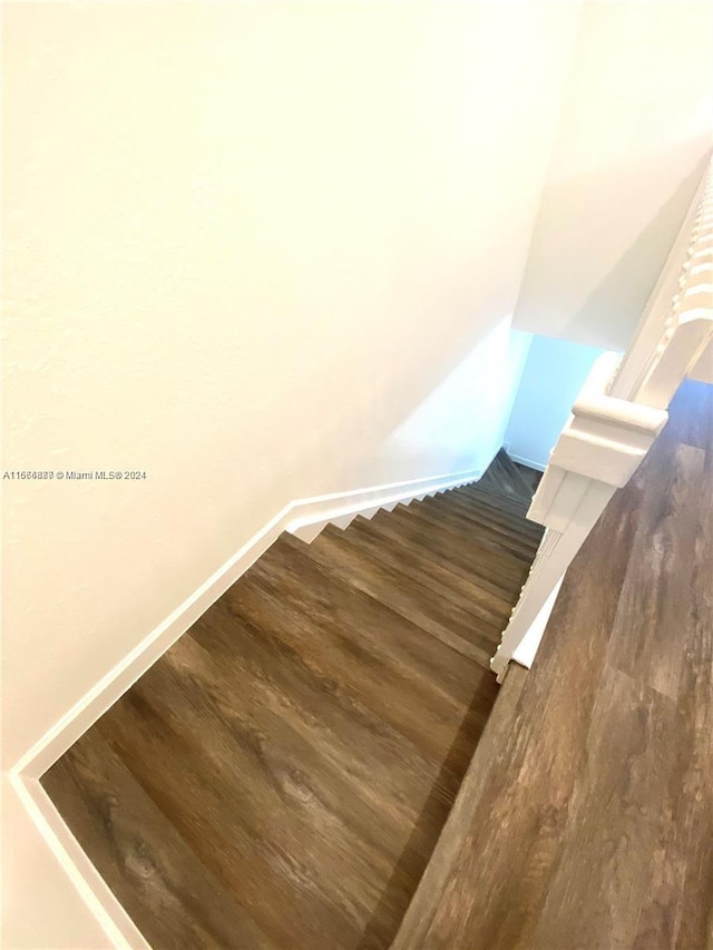 stairs with hardwood / wood-style floors