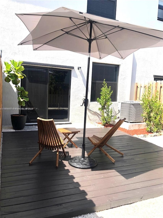 wooden deck featuring central AC unit