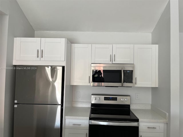 kitchen with stainless steel appliances and white cabinets