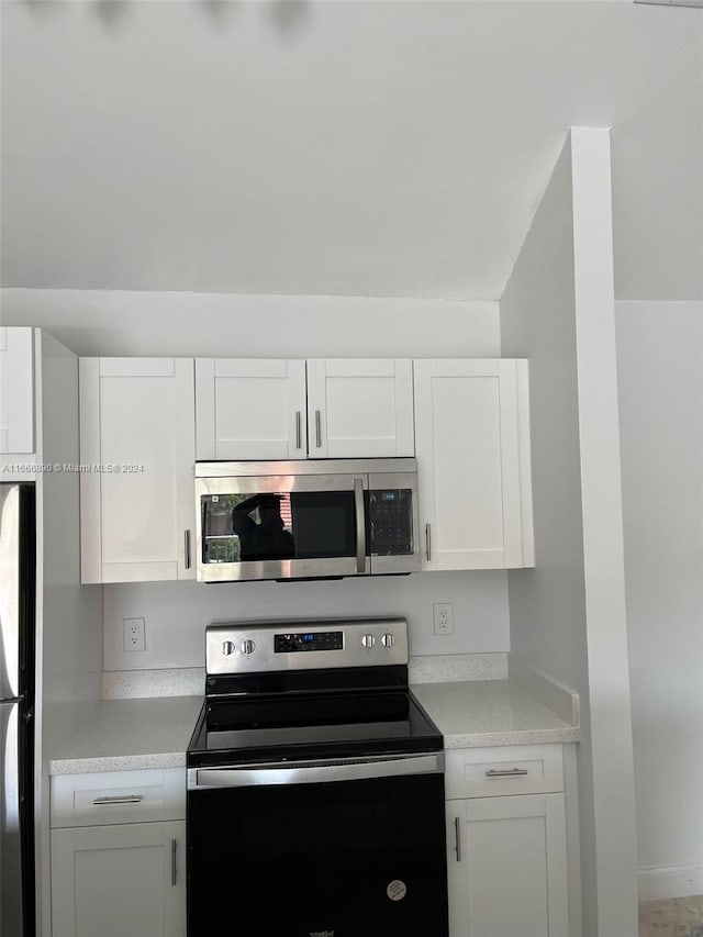 kitchen with white cabinets and appliances with stainless steel finishes