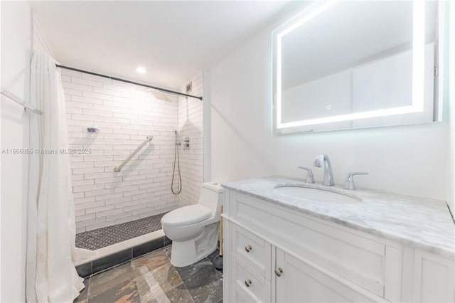 bathroom with vanity, curtained shower, and toilet