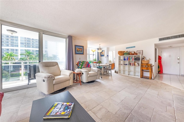 living area with visible vents and a textured ceiling