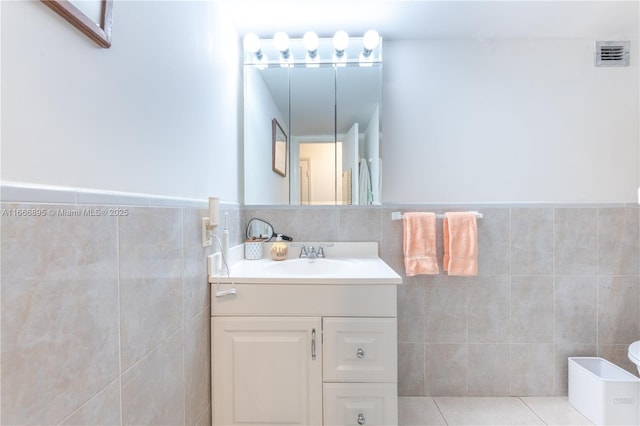1849 S Ocean Dr Unit 415, Hallandale Beach, FL 33009 - bathroom featuring tile walls, vanity, wainscoting, and tile patterned flooring