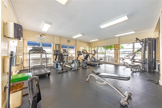 exercise room with a textured ceiling