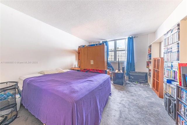 bedroom featuring carpet and a textured ceiling