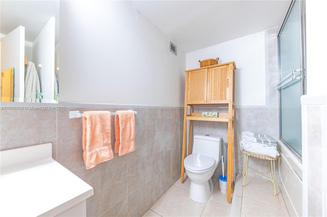 1849 S Ocean Dr Unit 415, Hallandale Beach, FL 33009 - bathroom with tile walls, toilet, tile patterned floors, a shower with door, and wainscoting