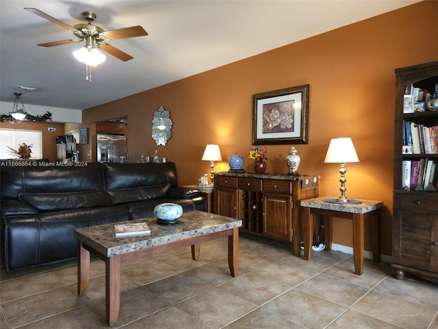 living room featuring ceiling fan and tile patterned floors