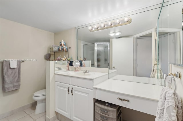 bathroom with vanity, a shower with shower door, tile patterned floors, and toilet