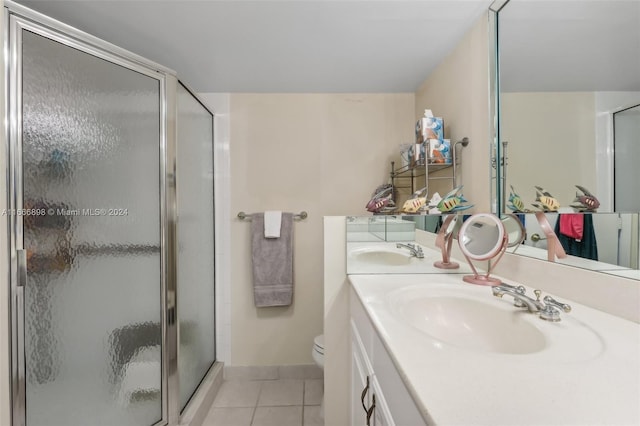 bathroom featuring tile patterned floors, toilet, an enclosed shower, and vanity