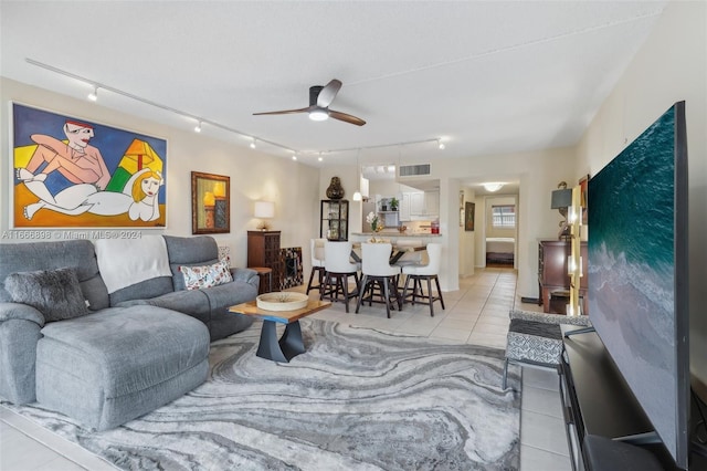 living room featuring ceiling fan and light tile patterned floors