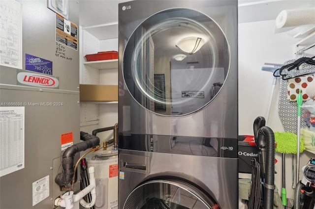 washroom featuring stacked washer / dryer and heating unit