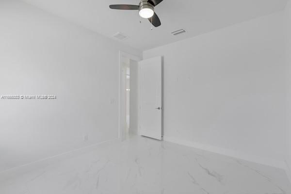 unfurnished room with ceiling fan