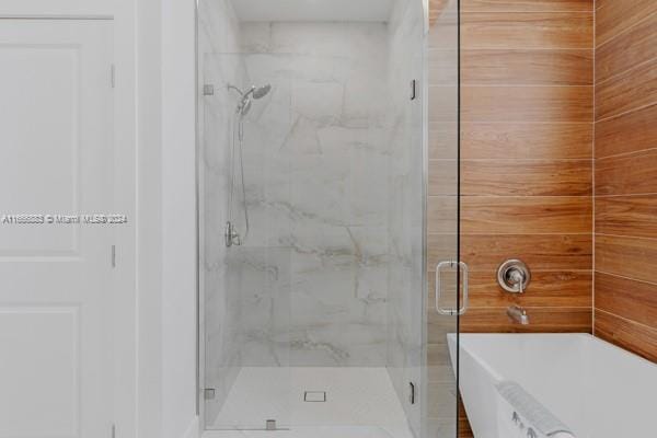 bathroom with separate shower and tub