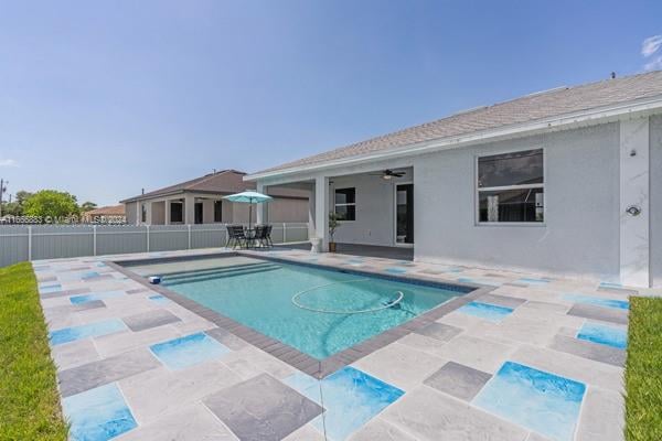 view of pool featuring ceiling fan and a patio area