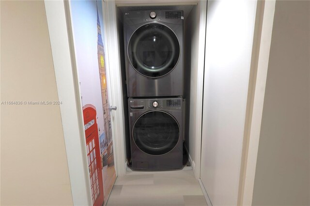 12750 SW 15th St Unit 106D, Pembroke Pines, FL 33027 - washroom with stacked washer and clothes dryer