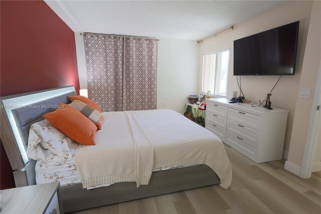 12750 SW 15th St Unit 106D, Pembroke Pines, FL 33027 - bedroom with light wood-style floors and baseboards