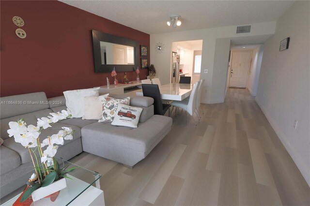 12750 SW 15th St Unit 106D, Pembroke Pines, FL 33027 - living area featuring light wood-style flooring and baseboards
