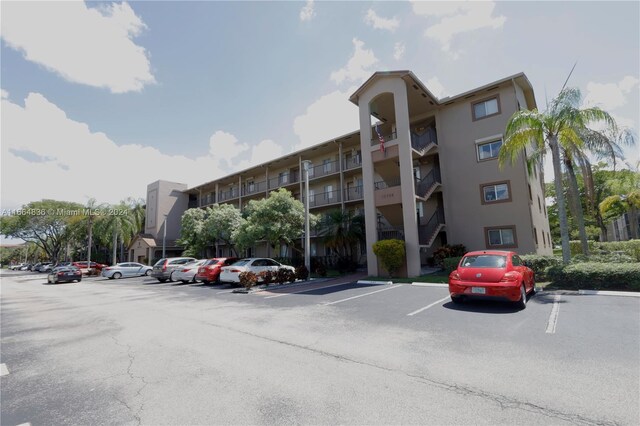 12750 SW 15th St Unit 106D, Pembroke Pines, FL 33027 - view of apartment building / complex featuring uncovered parking