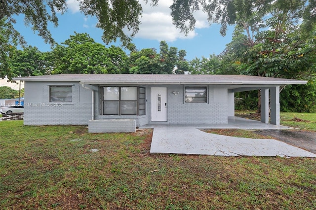 ranch-style house with a front lawn and a carport