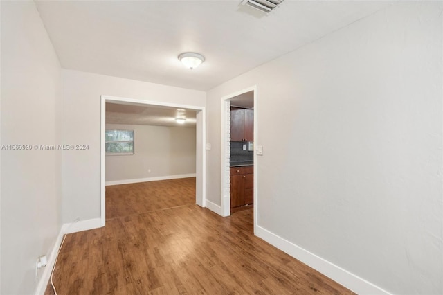 empty room with hardwood / wood-style floors