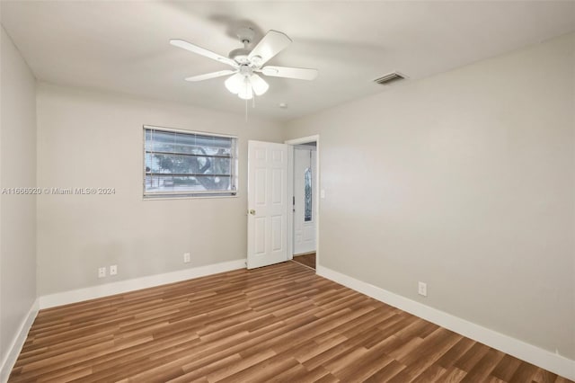 spare room with ceiling fan and hardwood / wood-style flooring