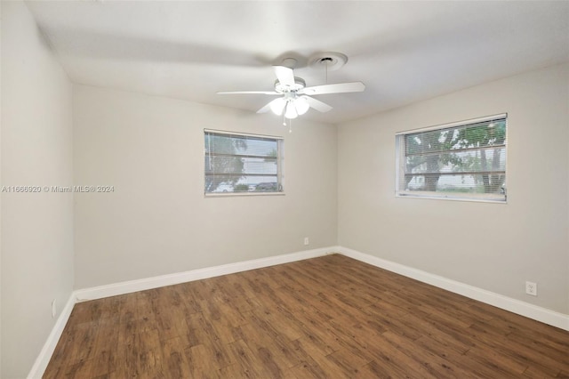 unfurnished room with ceiling fan and dark hardwood / wood-style flooring