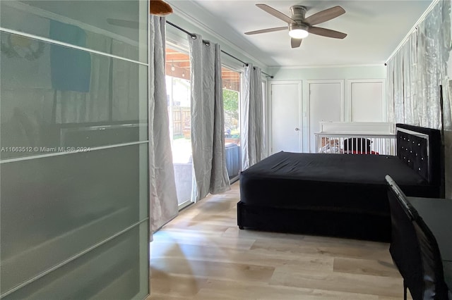 bedroom with light hardwood / wood-style flooring, ceiling fan, and crown molding