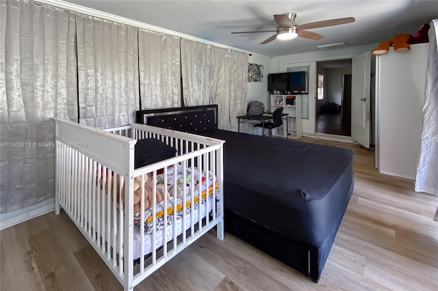 bedroom featuring wood-type flooring and ceiling fan