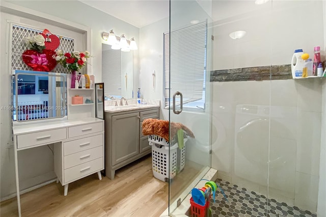 bathroom featuring walk in shower, vanity, and hardwood / wood-style flooring