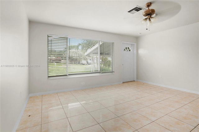 spare room with light tile patterned floors and ceiling fan