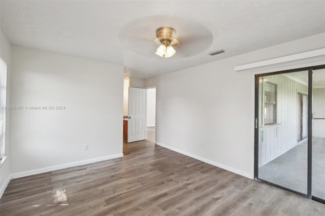 unfurnished room with ceiling fan and dark hardwood / wood-style flooring