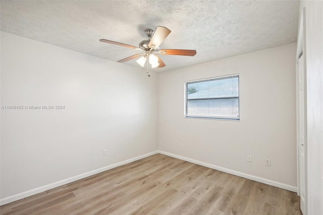 unfurnished room featuring light hardwood / wood-style floors, ceiling fan, and a textured ceiling