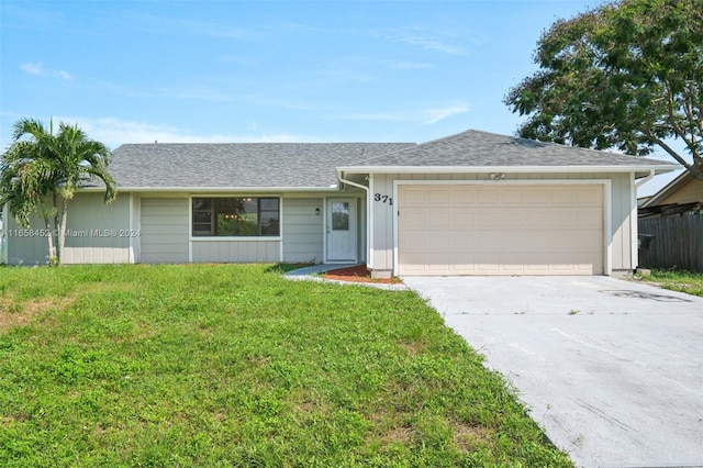 ranch-style house with a garage and a front lawn