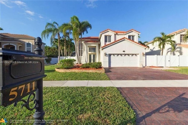 mediterranean / spanish house featuring a front yard