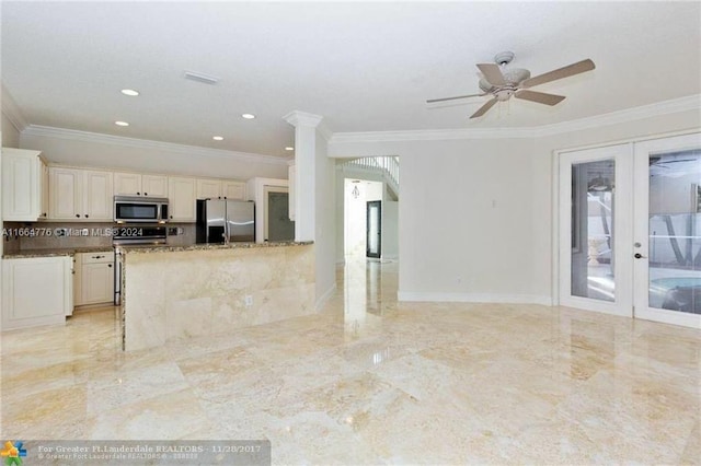 kitchen with stainless steel appliances, ceiling fan, french doors, and crown molding