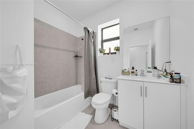 full bathroom with shower / bath combo with shower curtain, tile patterned floors, vanity, and toilet