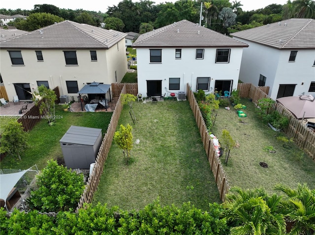 back of house with a patio, a yard, and central AC unit