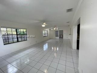 unfurnished room featuring ceiling fan and light tile patterned floors