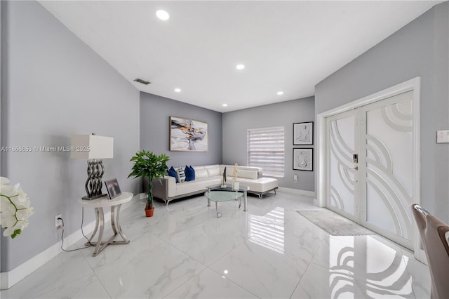 living area featuring baseboards, marble finish floor, visible vents, and recessed lighting