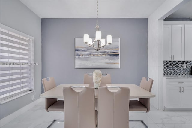 dining space with a chandelier and marble finish floor